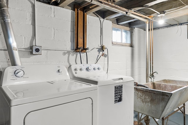 washroom with independent washer and dryer and sink