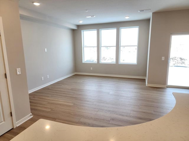 unfurnished room with light hardwood / wood-style floors