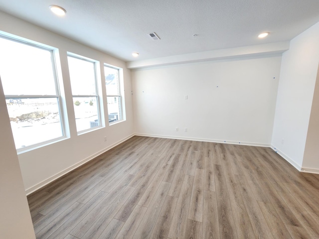 unfurnished room featuring light hardwood / wood-style floors