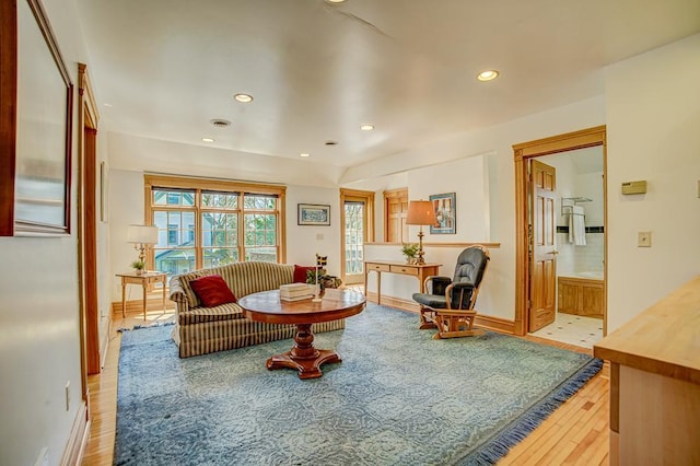 living room with baseboards, recessed lighting, and light wood-style flooring