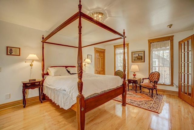 bedroom with baseboards and light wood finished floors