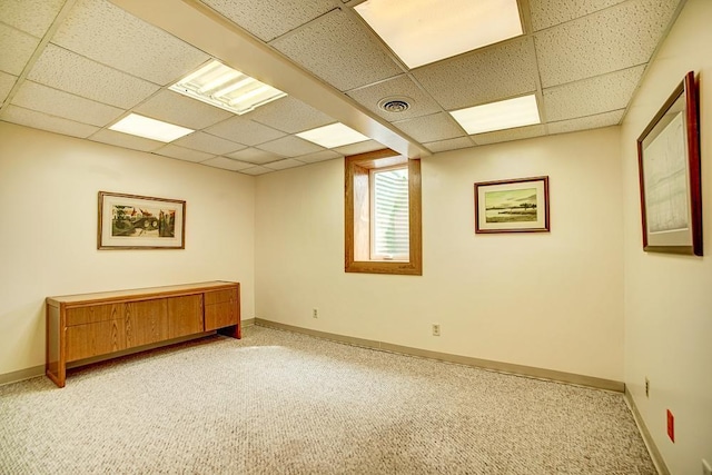 unfurnished room with visible vents, a paneled ceiling, baseboards, and light carpet