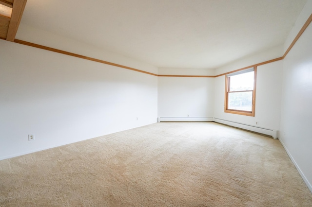 spare room featuring a baseboard radiator and carpet