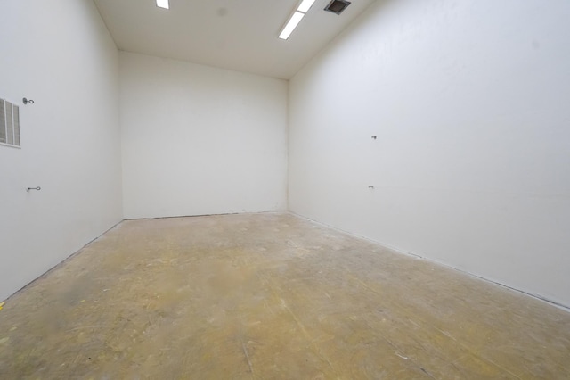 empty room featuring lofted ceiling