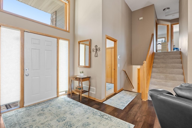 entrance foyer with a high ceiling and dark hardwood / wood-style floors