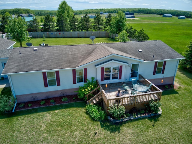 back of house with a deck and a yard