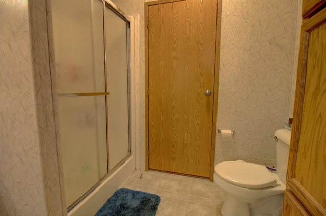 bathroom featuring toilet and walk in shower