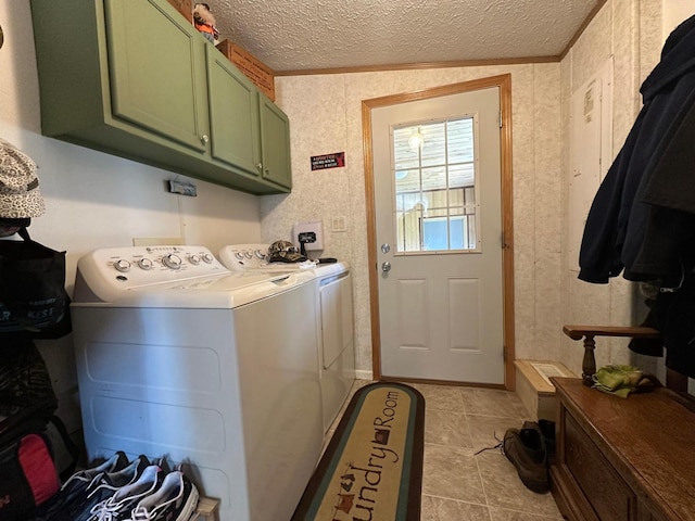 washroom featuring cabinets, a textured ceiling, independent washer and dryer, and light tile patterned flooring