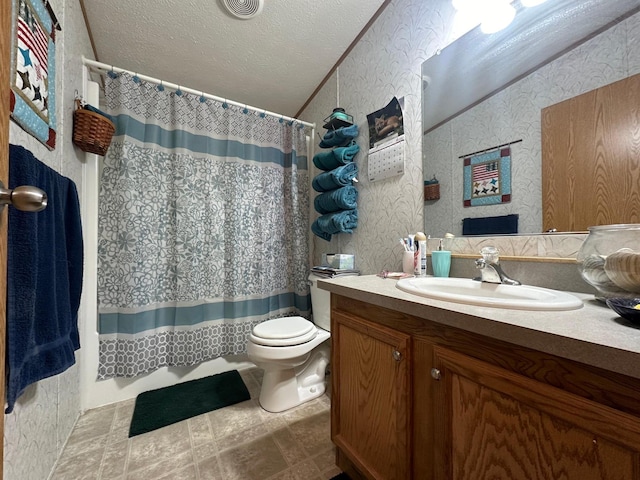 bathroom with a textured ceiling, toilet, vanity, and a shower with curtain