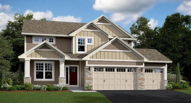 craftsman-style home featuring a front lawn and a garage