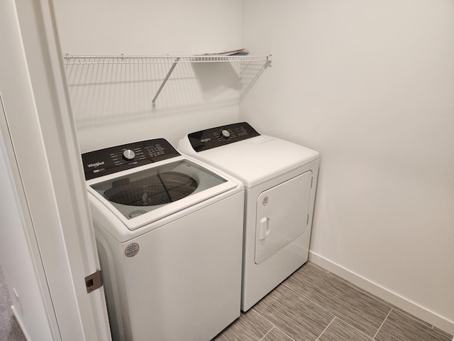 clothes washing area with independent washer and dryer