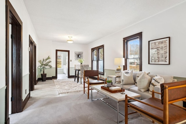 living room with a textured ceiling and light hardwood / wood-style flooring