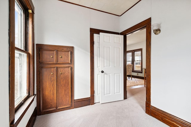 unfurnished bedroom featuring ornamental molding and light colored carpet