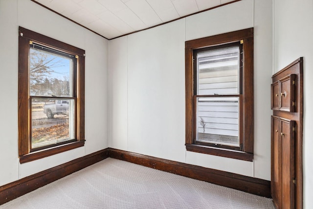 carpeted empty room with crown molding