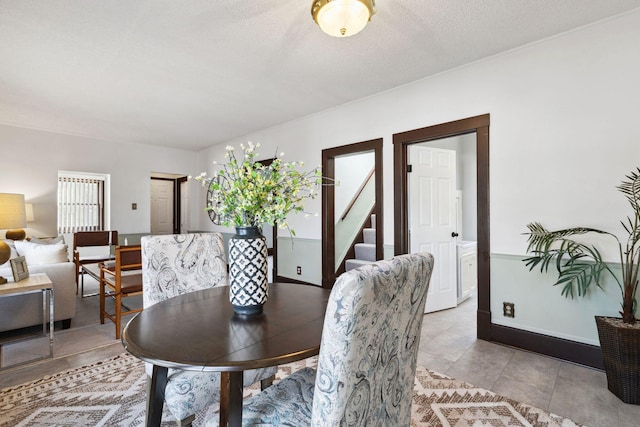 dining space featuring a healthy amount of sunlight and a textured ceiling