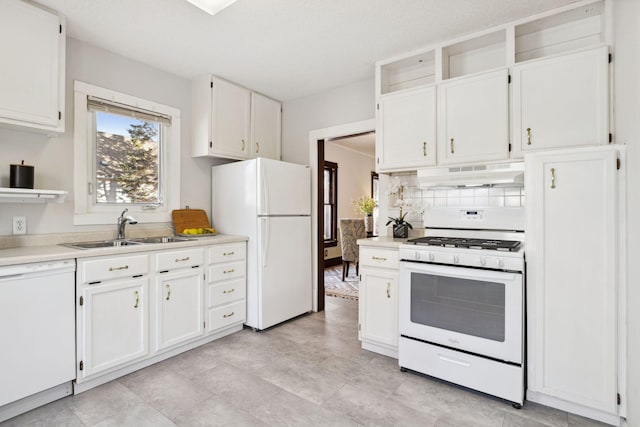 kitchen with white cabinetry, white appliances, sink, and tasteful backsplash