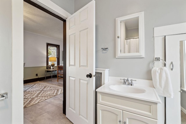 bathroom featuring vanity, tile patterned floors, and a textured ceiling