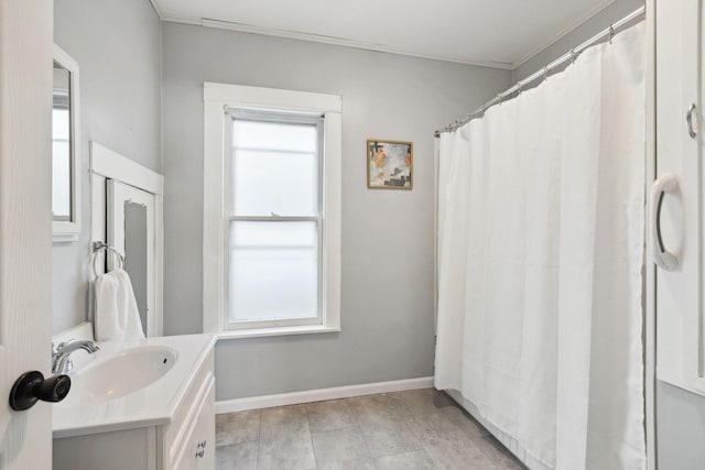 bathroom with crown molding and vanity