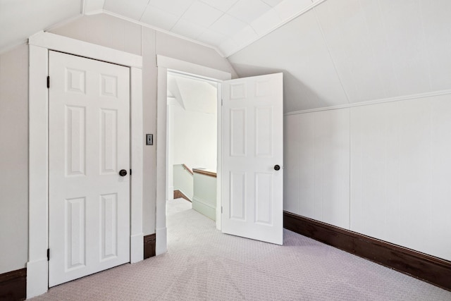 bonus room featuring vaulted ceiling and light carpet