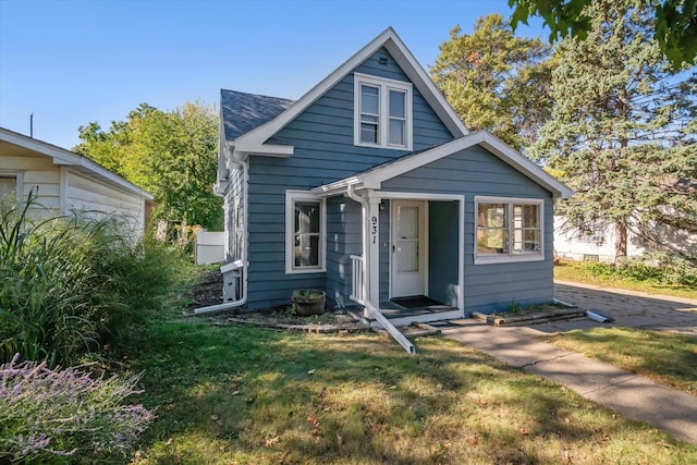 bungalow-style house featuring a front yard