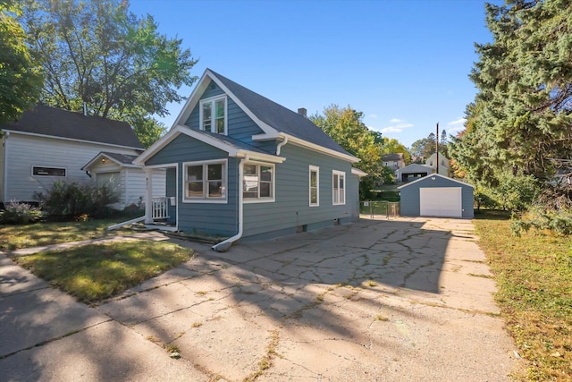 view of front of home with a garage and an outdoor structure