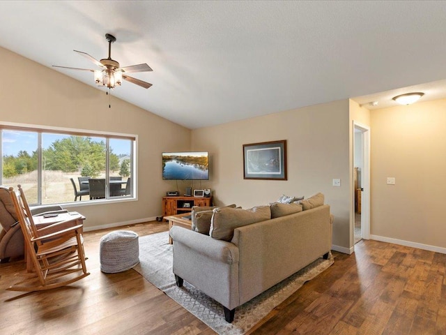 living room featuring lofted ceiling, wood finished floors, a ceiling fan, and baseboards