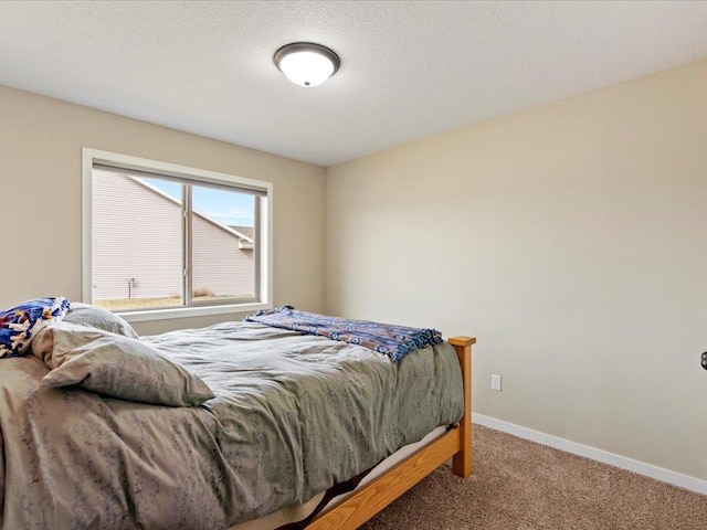 carpeted bedroom with baseboards