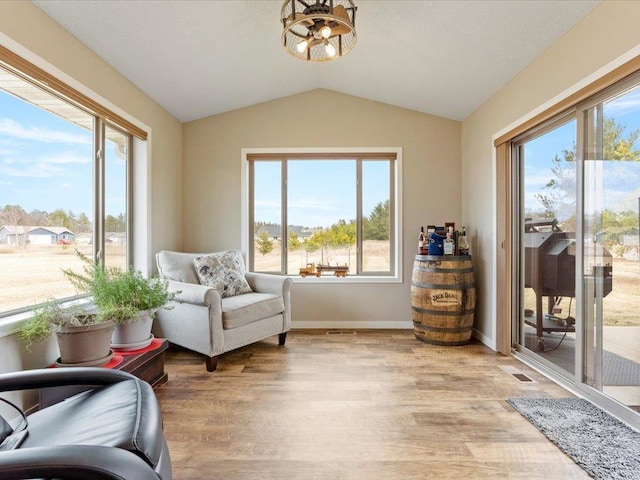 15104 Wild Ave, Brainerd, MN 56401 - sitting room featuring lofted ceiling, a chandelier, and light wood-style flooring