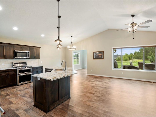 15104 Wild Ave, Brainerd, MN 56401 - kitchen with stainless steel appliances, dark brown cabinetry, lofted ceiling, wood finished floors, and open floor plan