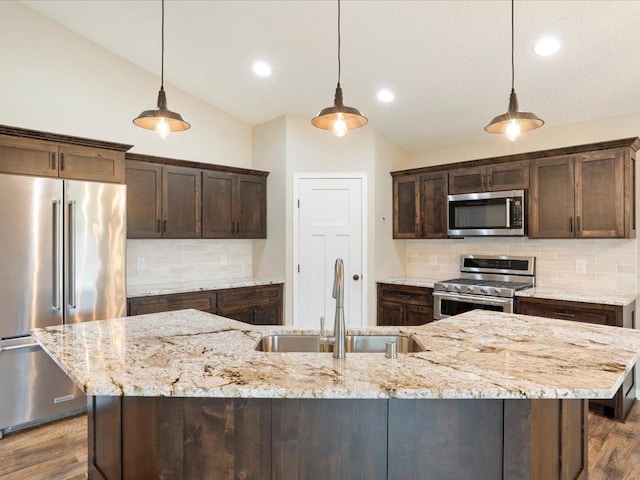 15104 Wild Ave, Brainerd, MN 56401 - kitchen with stainless steel appliances, vaulted ceiling, dark brown cabinets, decorative backsplash, and dark wood finished floors