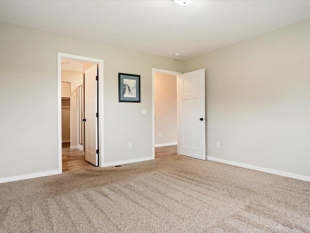 15104 Wild Ave, Brainerd, MN 56401 - unfurnished bedroom with carpet flooring, a walk in closet, and a closet