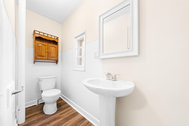 bathroom featuring hardwood / wood-style floors and toilet