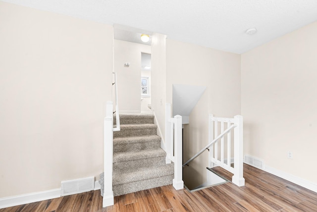 staircase featuring hardwood / wood-style flooring