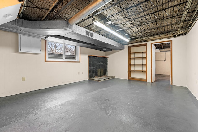 basement with a stone fireplace