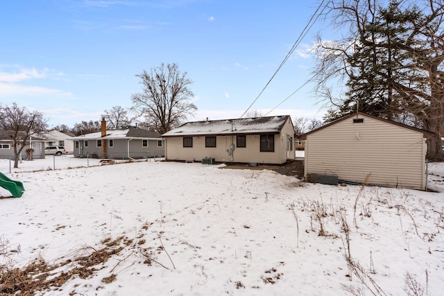 snow covered property featuring central air condition unit