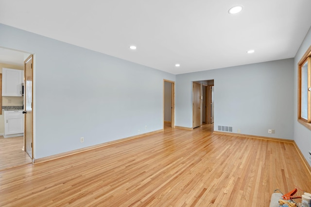 spare room featuring light wood-type flooring