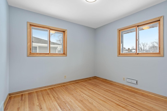 unfurnished room with light hardwood / wood-style floors