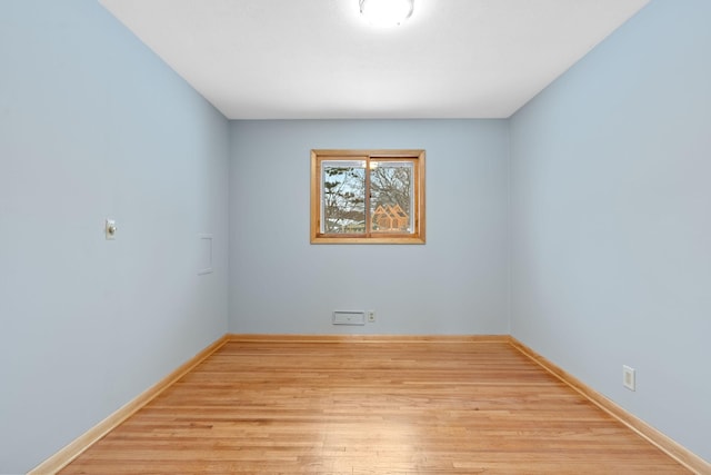 empty room with light hardwood / wood-style floors