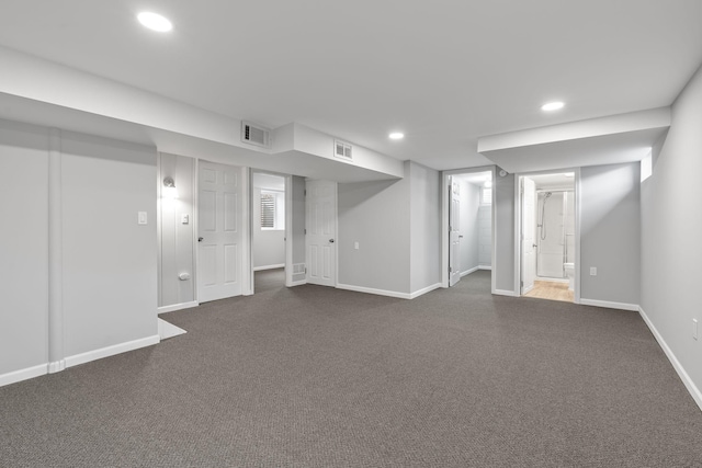 basement featuring dark colored carpet