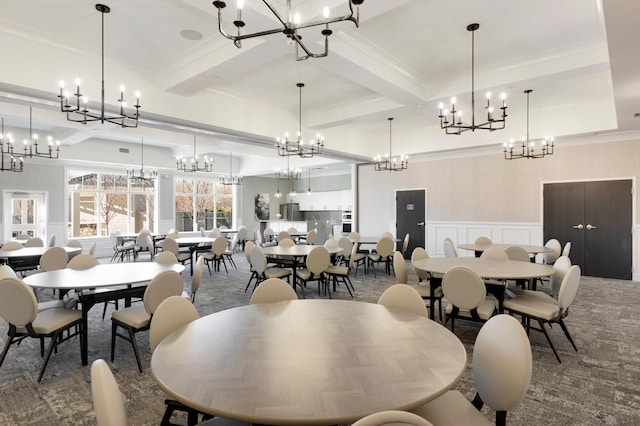 dining room featuring crown molding, beam ceiling, and carpet