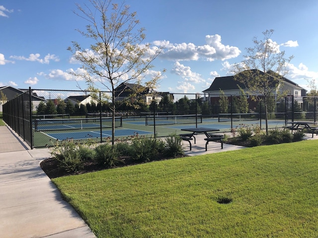 view of sport court with a yard