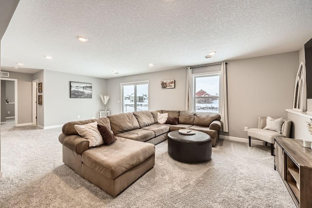 living room featuring light carpet and a textured ceiling