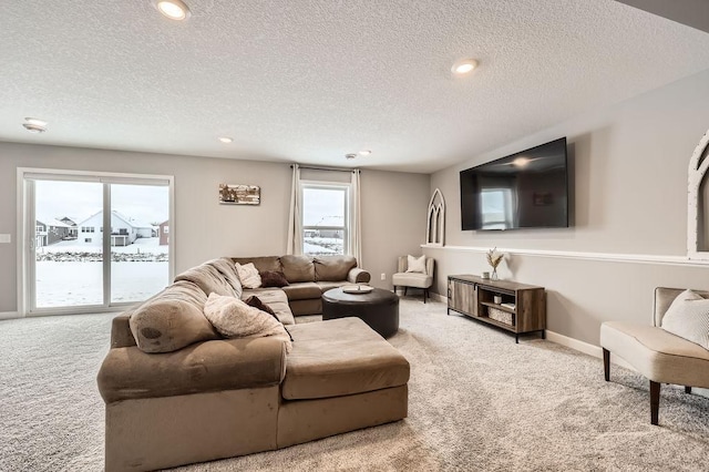 living room featuring a textured ceiling and light carpet