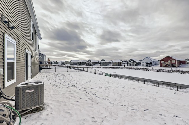 yard covered in snow featuring central air condition unit