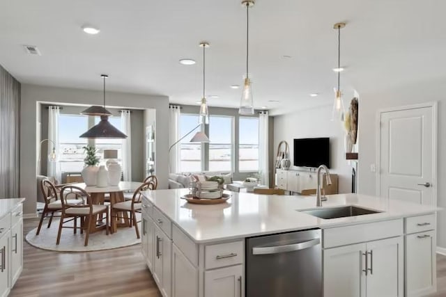 kitchen with dishwasher, sink, a wealth of natural light, and white cabinets