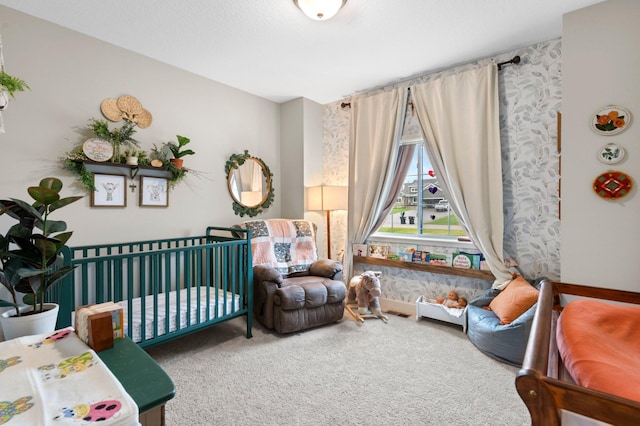 bedroom featuring a crib and carpet flooring