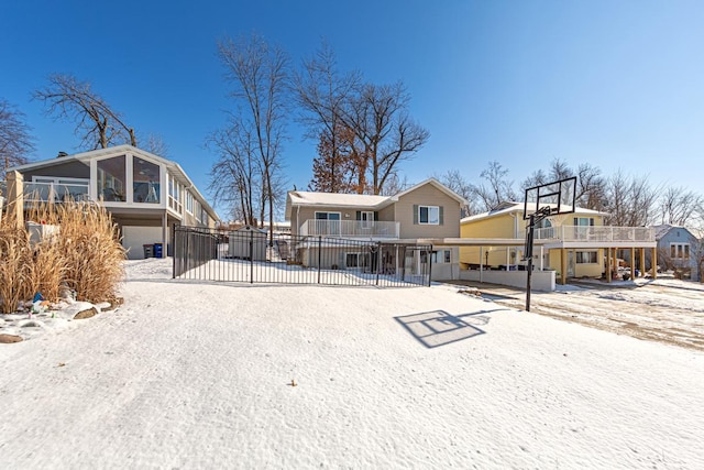 view of snow covered rear of property