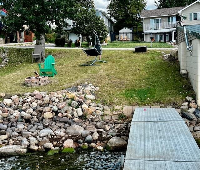 view of yard featuring a fire pit and fence