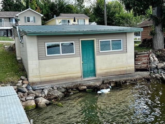 view of outbuilding with entry steps and a water view