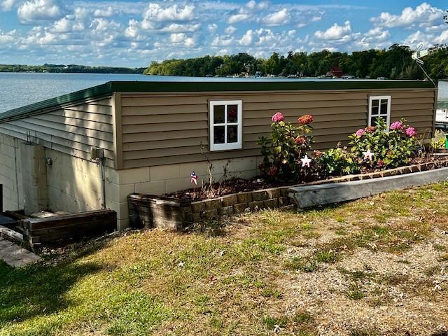 view of property exterior featuring a water view